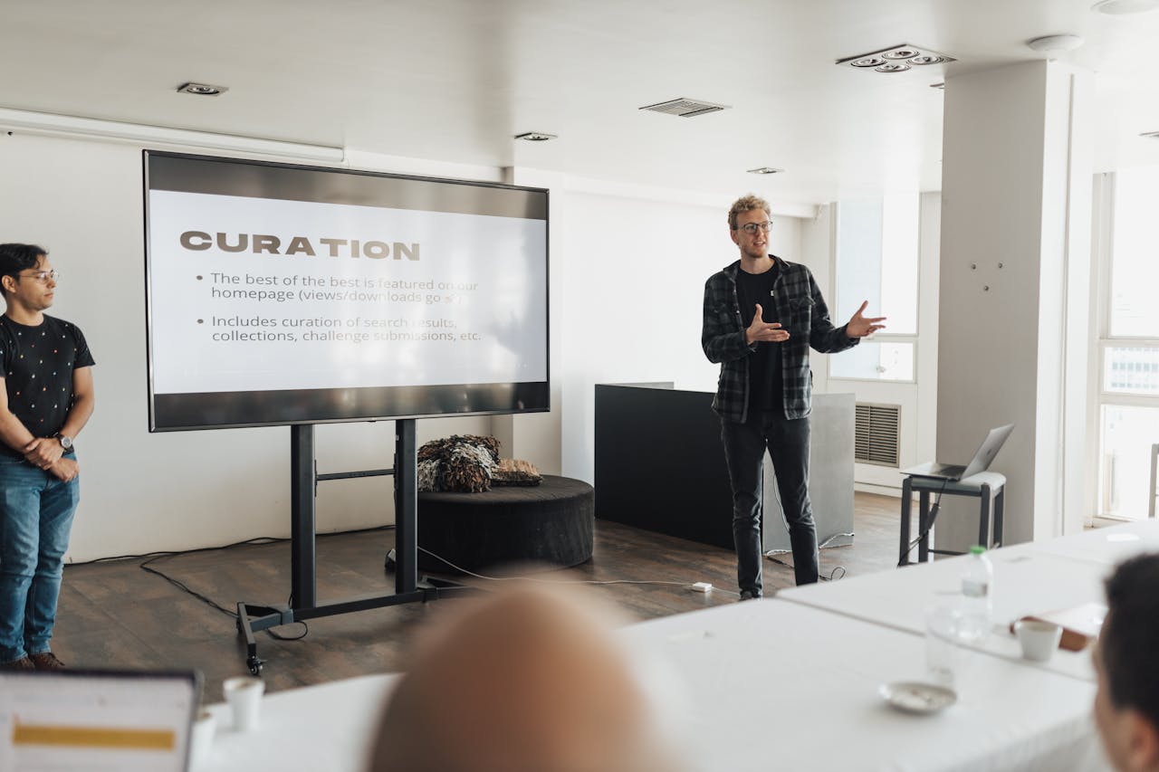 A professional giving a business presentation in a modern office setting, engaging the audience.